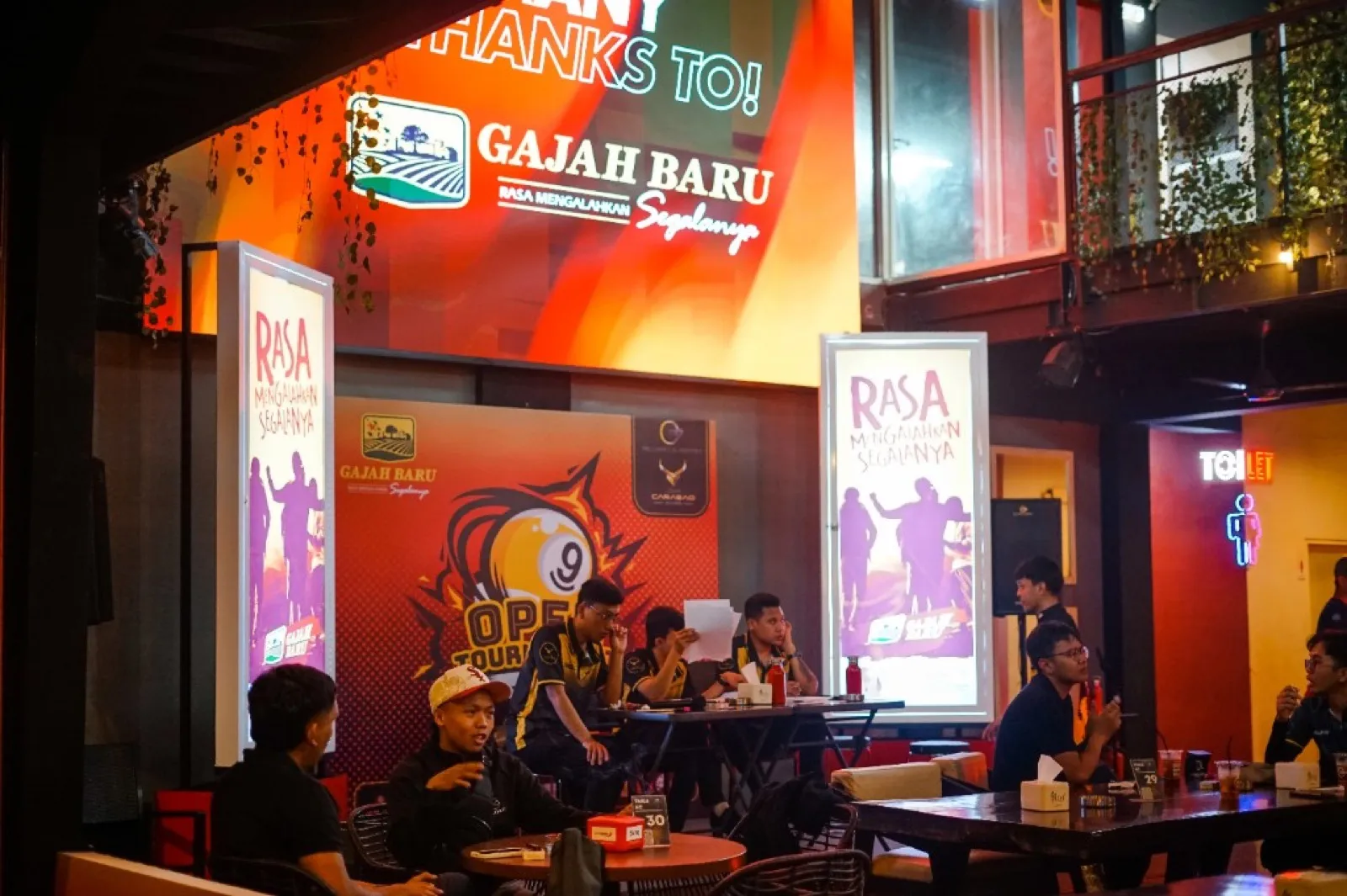 Indoor tournament lounge with Gajah Baru branding