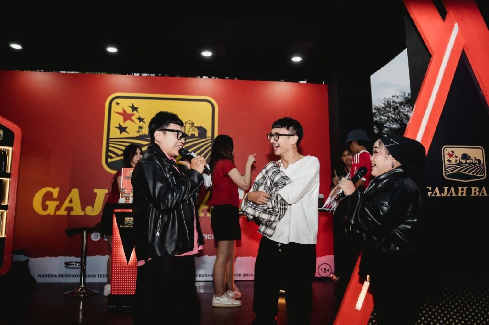 Hosts on stage at a Gajah Baru event booth